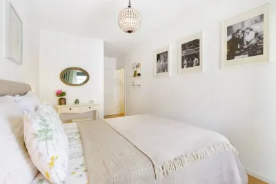 Experience ultimate relaxation in our stylish bedroom, boasting a sumptuous bed.
