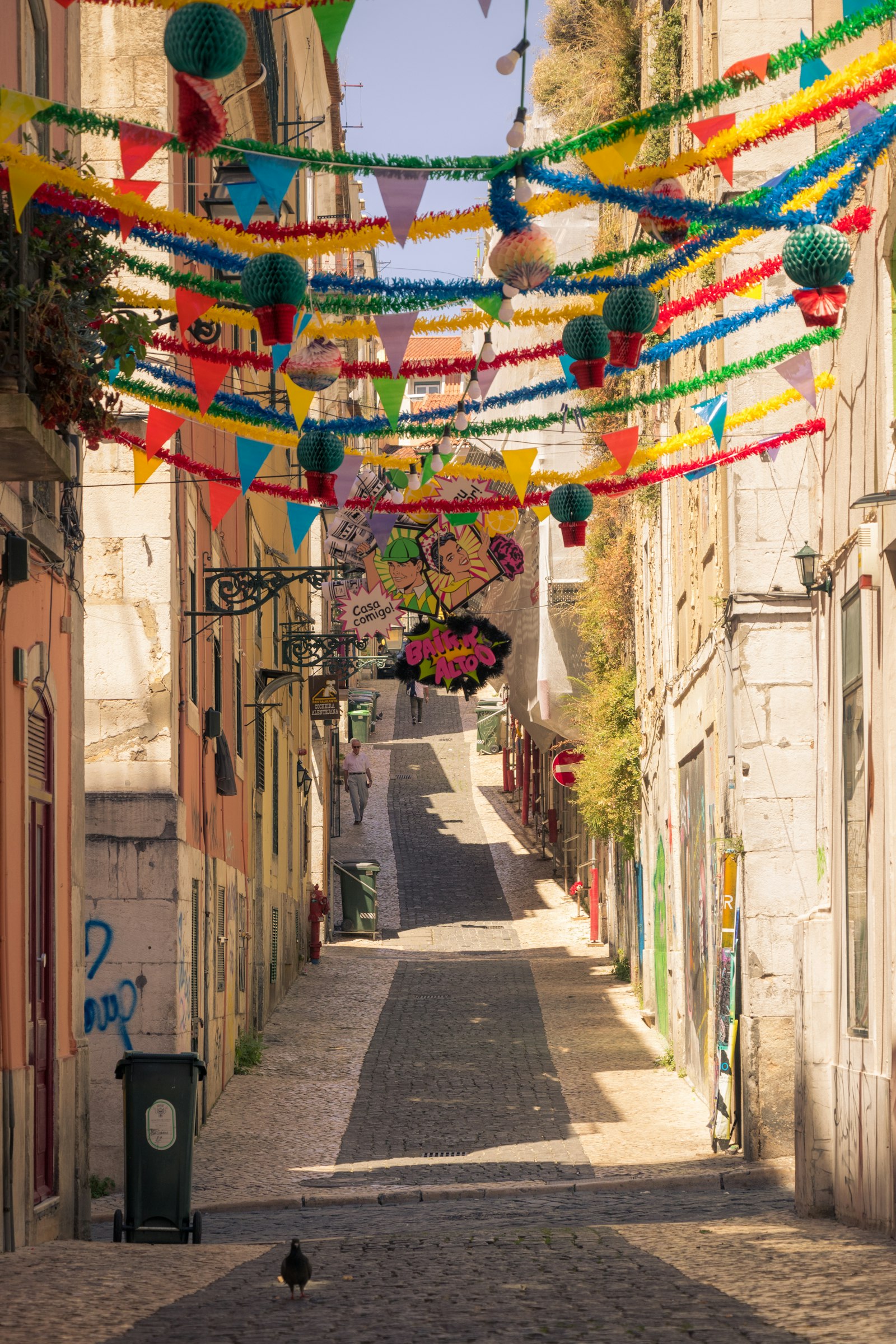 Narrow Lisbon street at night with festival decorations